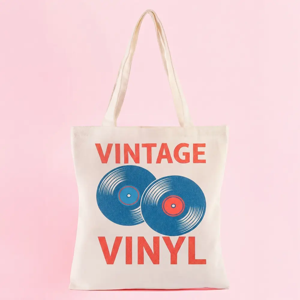 Natural canvas tote bag with Vintage Vinyl retro record graphic print in blue and red on pink background