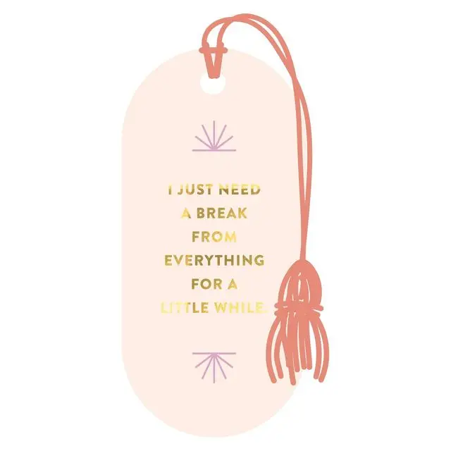 Blush pink vegan leather bookmark with gold foil text reading I Just Need A Break From Everything For A Little While, coral tassel and lavender starburst accents on white background