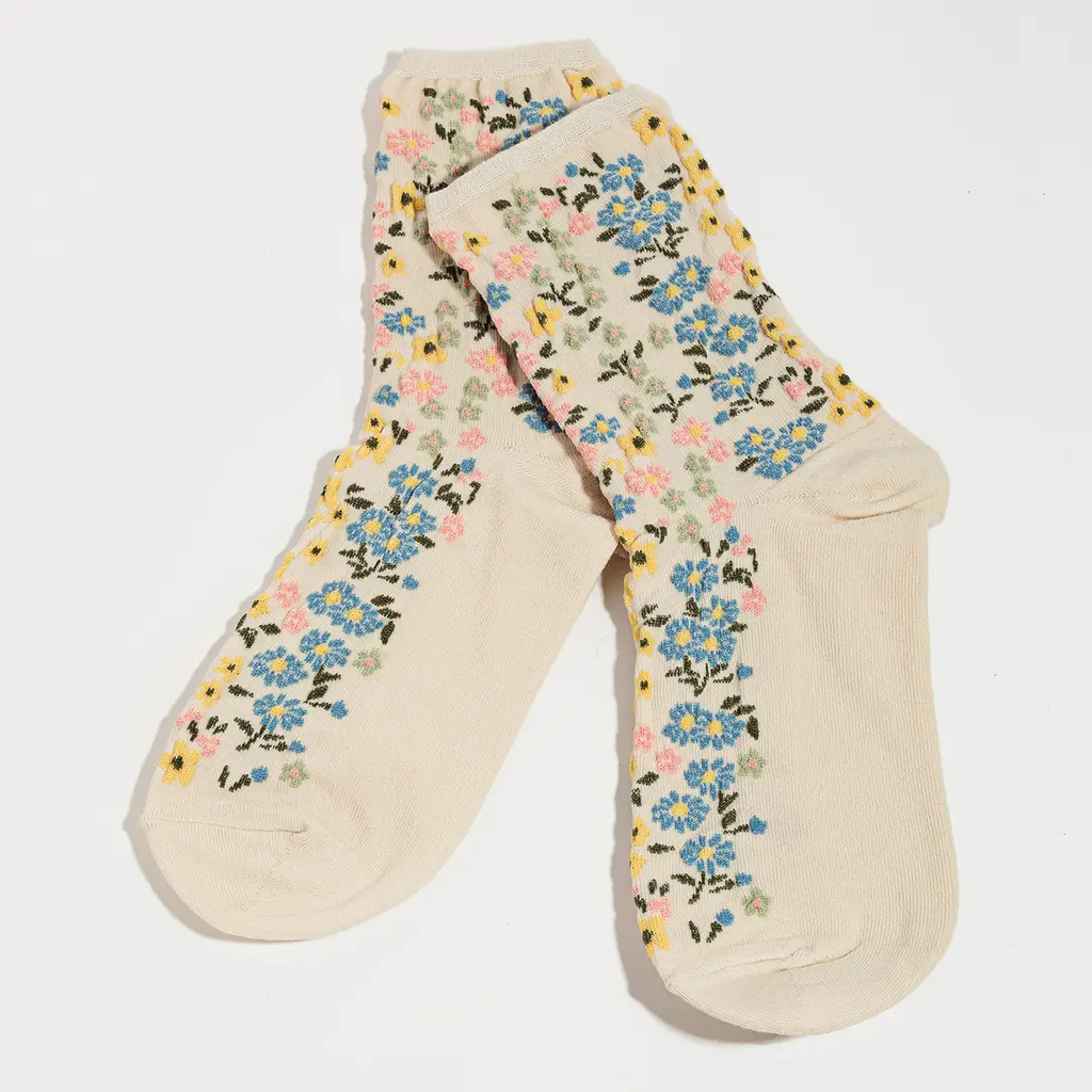 Cream crew socks with all-over wildflower ditsy floral pattern in blue pink yellow and sage green